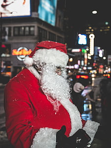 man wearing Santa Claus costume standing near road thumbnail