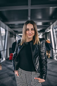 woman standing on footbridge while taking selfie thumbnail