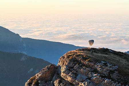 man standing on mountain cliff thumbnail