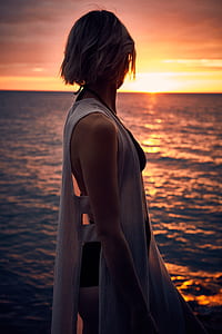 woman standing near water thumbnail