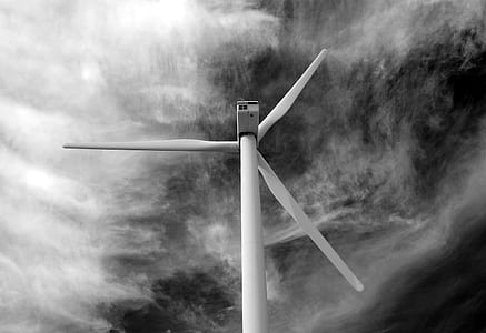 grayscale windmill under cloudy sky thumbnail