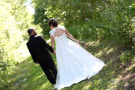 couple walking on green road during daytime thumbnail