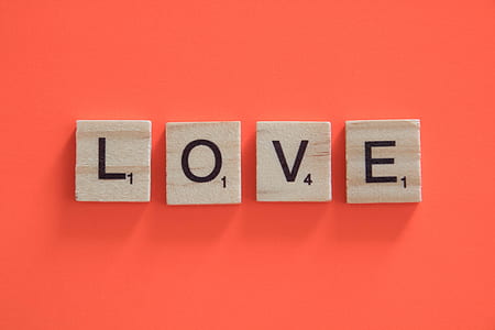 Love scrabble piece on pink surface thumbnail