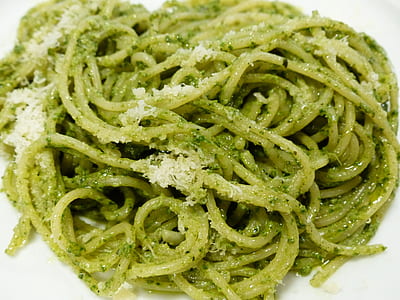 green pasta with sauce on white plate thumbnail