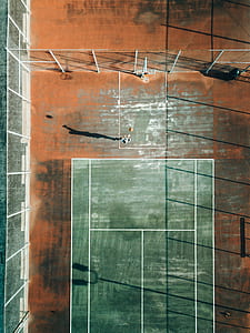 top view photography of man playing basket on court during daytime thumbnail