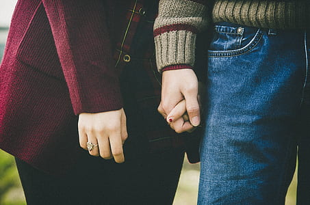photo of woman and man holding hands together thumbnail