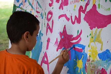 boy holding paint brush thumbnail