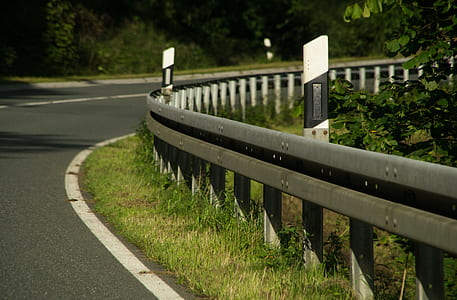 curve road near barriers and trees thumbnail
