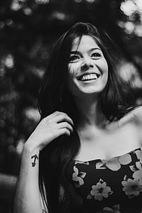grayscale photography of smiling woman holding her hair thumbnail