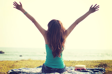 brown haired woman raising her arms thumbnail
