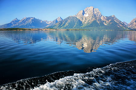 mountain near body of water under blue sky at daytime thumbnail