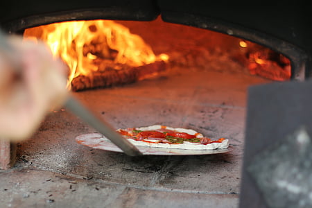 person holding gray metal pizza holder thumbnail