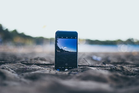 smartphone on beach sand thumbnail
