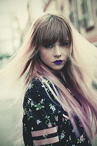 woman in black floral top looking back thumbnail