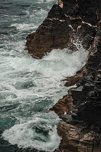 Brown Mountain Splashed With Water from Sea thumbnail
