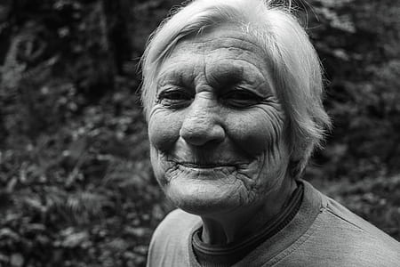 greyscale photo woman near plant thumbnail