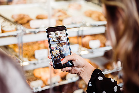 woman holding iPhone 6 capturing bread thumbnail