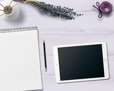 silver iPad near pencil and sketch pad thumbnail