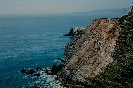 rocky cliffs and sea during daytime thumbnail