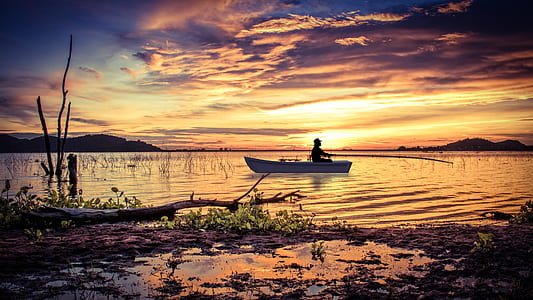 person in canoe on body of water thumbnail