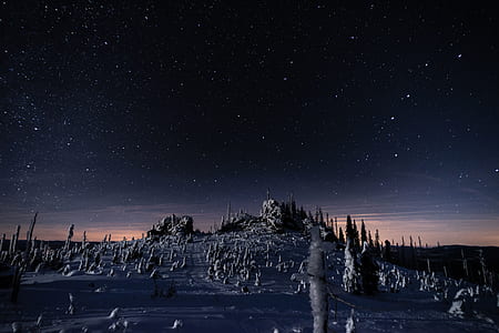 gray rock formations under starry night thumbnail