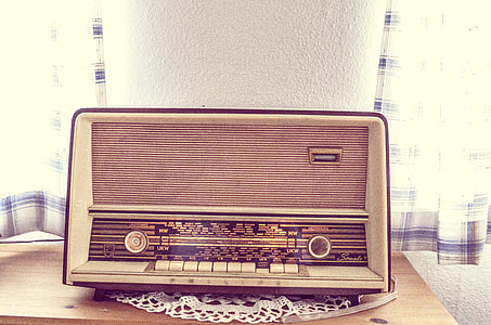 white tuner radio on brown wooden table thumbnail