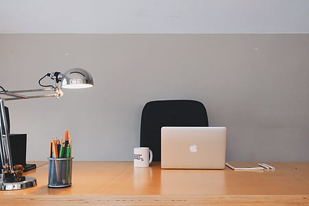 silver Apple MacBook beside white ceramic mug on brown wooden table thumbnail