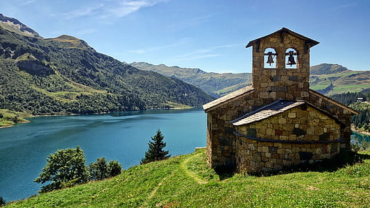 brown concrete building near body of water during daytime thumbnail