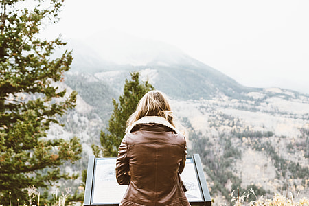 woman standing on mountain peak thumbnail