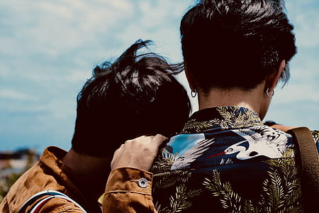 man leaning on shoulder of a woman under cloudy skies thumbnail