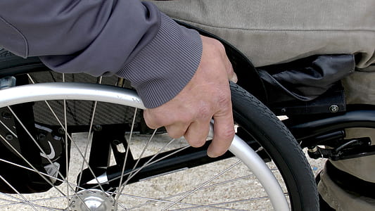 person sits on chrome-colored wheelchair thumbnail