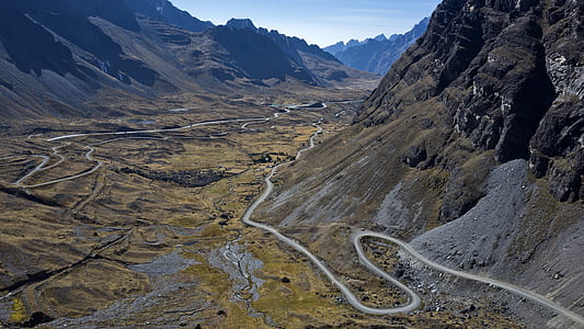 aerial view of zigzag road near mountain thumbnail