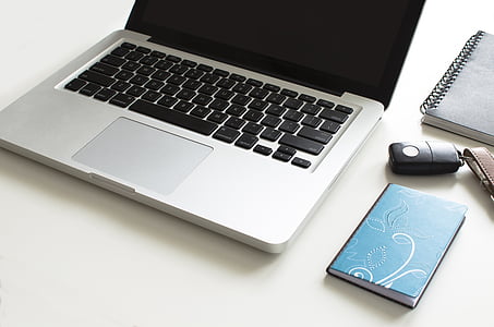 MacBook Pro beside black key fob thumbnail