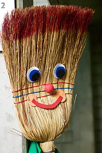 brown and red broom decor beside white wall thumbnail