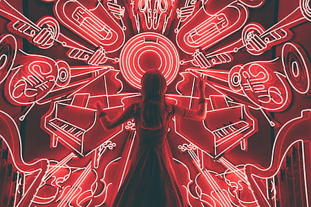 woman black dress facing neon signage during nighttime thumbnail
