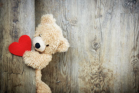 brown bear plush toy holding red heart ornament thumbnail