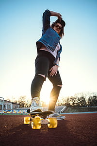 low-angle of woman skateboarding thumbnail
