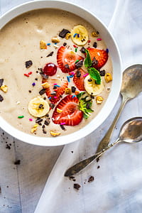 fruit salad in bowl beside two spoons thumbnail