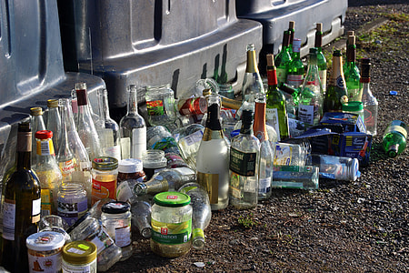 assorted-brand bottle lot beside black plastic containers thumbnail