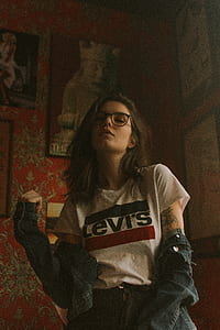 woman standing beside red wall thumbnail