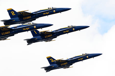 four blue US Navy fighter planes flying at daytime thumbnail