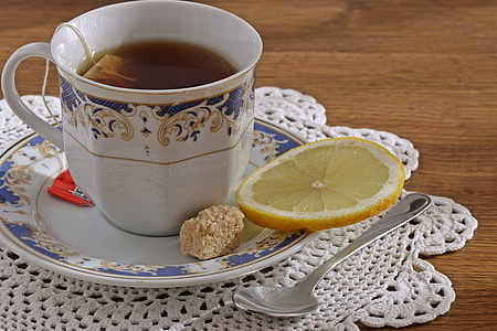 clear glass mug on saucer beside spoon thumbnail