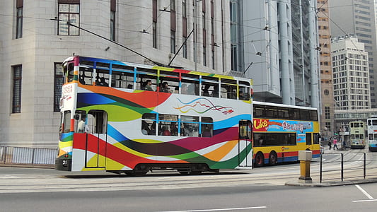 white, red, and yellow double-decker bus on road thumbnail