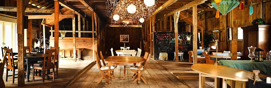 brown wooden oval tables and chairs on brown wood planks thumbnail