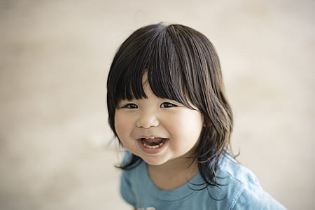 smiling girl wearing blue shirt thumbnail