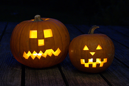 two pumpkin with lights on brown wooden surface thumbnail