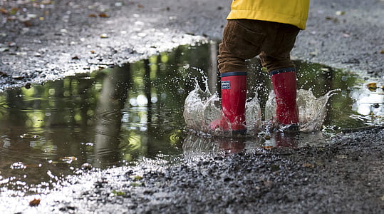 person wearing red-and-black rain boots thumbnail