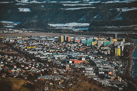 aerial photography of city near mountain at daytime thumbnail
