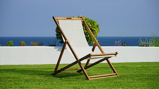 brown and white outdoor folding lounge chair under sunny sky thumbnail