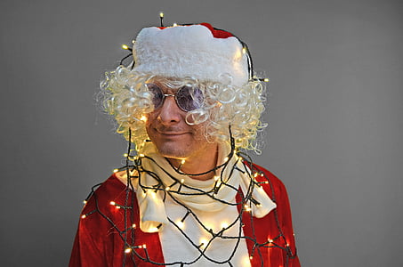man dressed as Santa Claus wrapped in string lights thumbnail